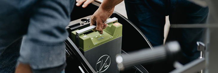  Rider riding VIDA electric scooter after charging it.