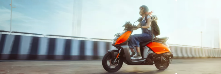  Rider riding VIDA electric scooter after charging it.