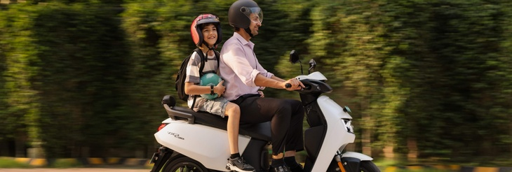  Rider riding VIDA electric scooter after charging it.