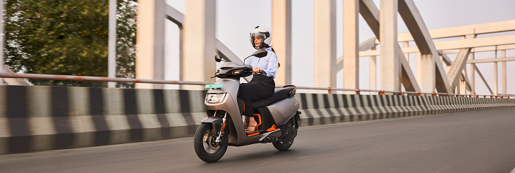  Rider riding VIDA electric scooter after charging it.