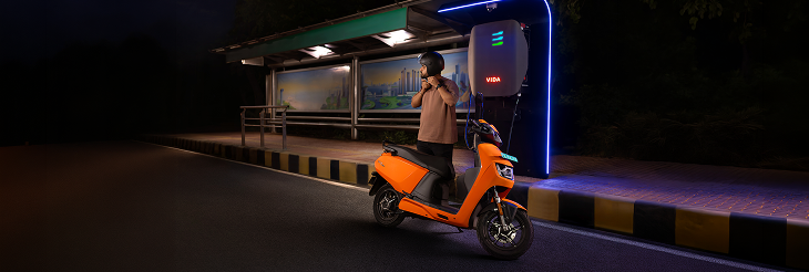  Rider riding VIDA electric scooter after charging it.
