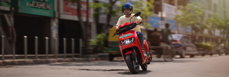  Rider riding VIDA electric scooter after charging it.