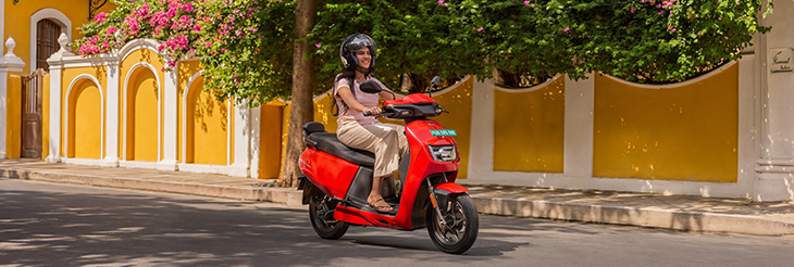  Rider riding VIDA electric scooter after charging it.