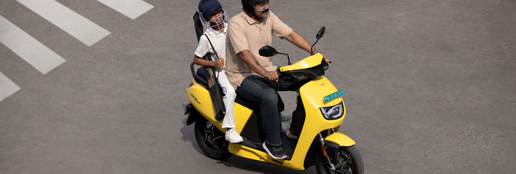  Rider riding VIDA electric scooter after charging it.
