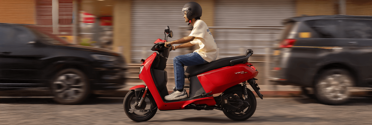  Rider riding VIDA electric scooter after charging it.