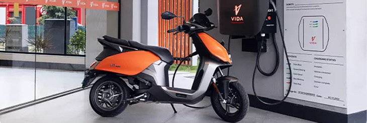  Rider riding VIDA electric scooter after charging it.