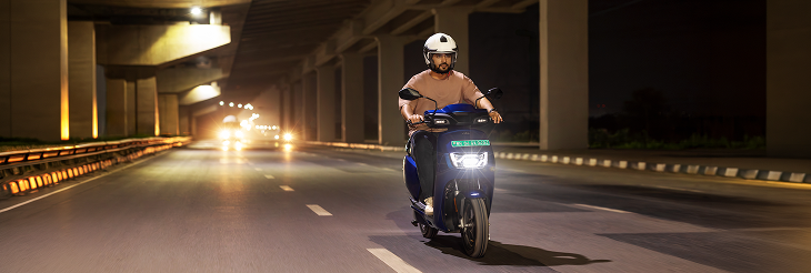  Rider riding VIDA electric scooter after charging it.