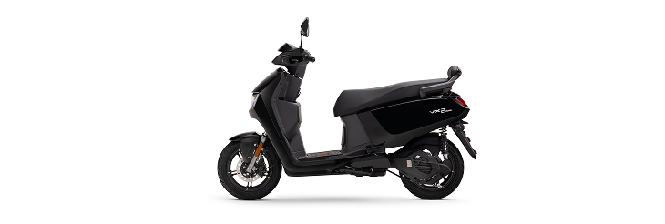  Rider riding VIDA electric scooter after charging it.