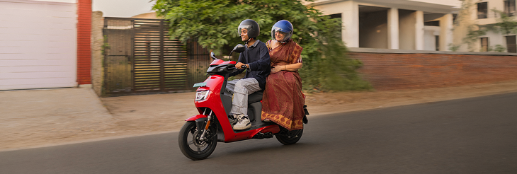 Rider riding VIDA electric scooter after charging it.
