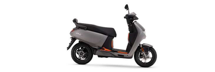  Rider riding VIDA electric scooter after charging it.