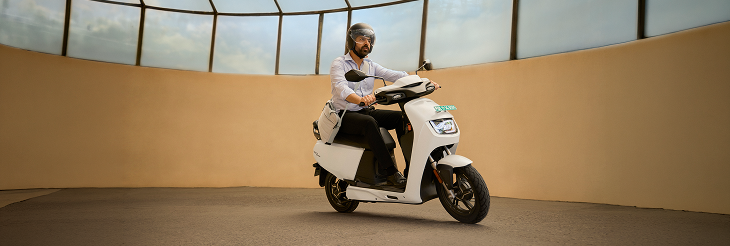  Rider riding VIDA electric scooter after charging it.