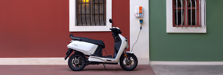  Rider riding VIDA electric scooter after charging it.