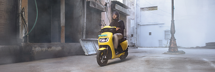  Rider riding VIDA electric scooter after charging it.