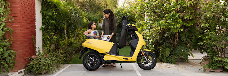  Rider riding VIDA electric scooter after charging it.