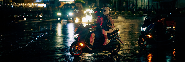  Rider riding VIDA electric scooter after charging it.