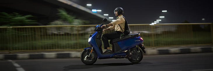  Rider riding VIDA electric scooter after charging it.